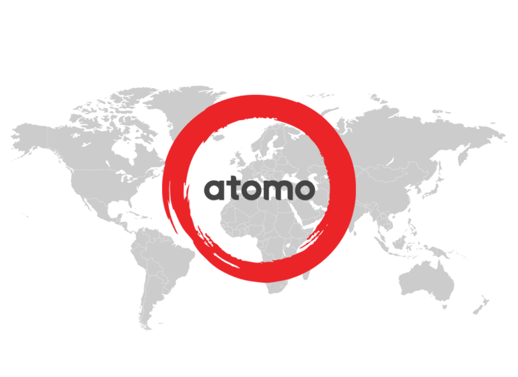 Atomo World Grey flat map of the world with the Atomo logo in red and dark grey sitting on top