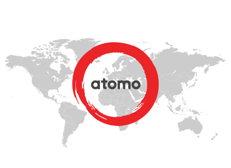 Grey flat map of the world with the Atomo logo in red and dark grey sitting on top