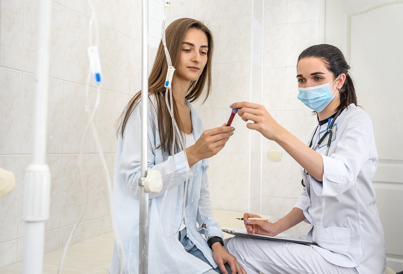 Point of Care Diagnostic Testing Patient in hospital with doctor holding clipboard