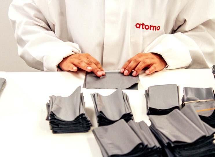Lateral Flow Manufacturing person in lab coat assembling product