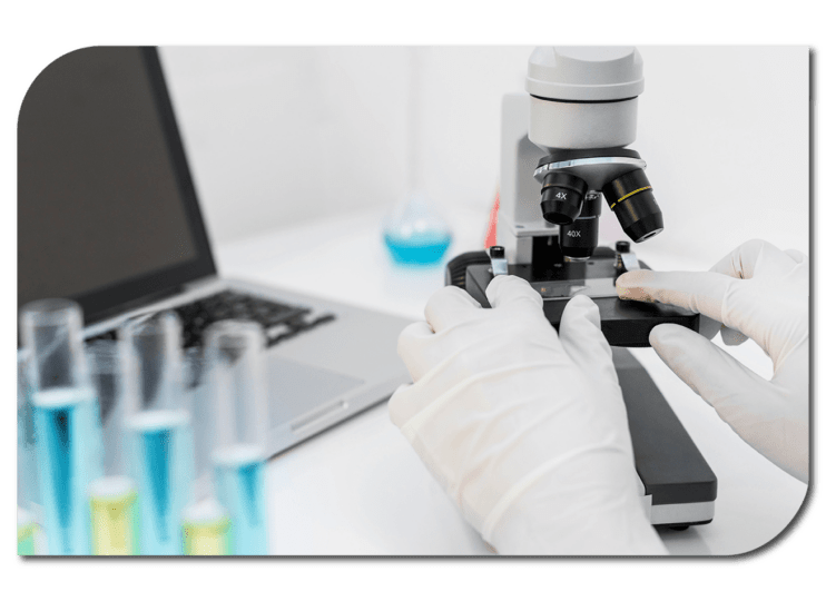 Gloved hands using microscope