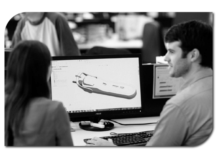 A man and woman collaborating on a computer in an office, focusing on their work together.