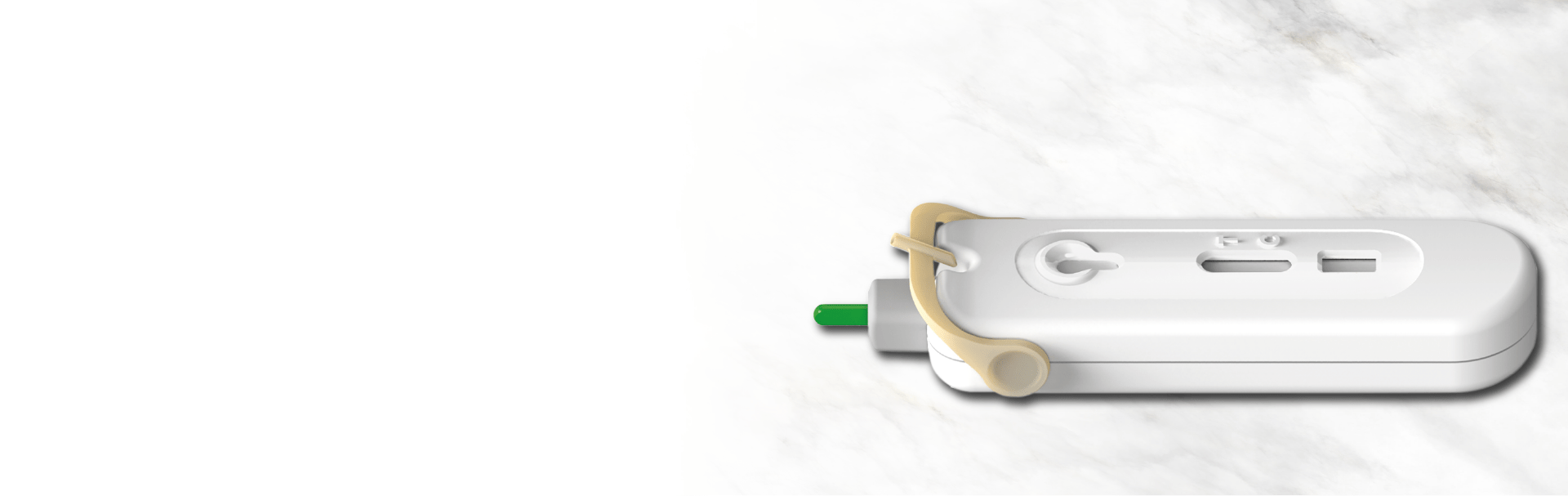 White and green diagnostic device on marble surface.